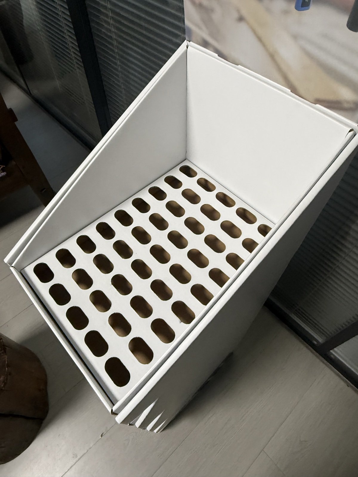 Tray detail showing die-cut holes and reinforced shelf edge