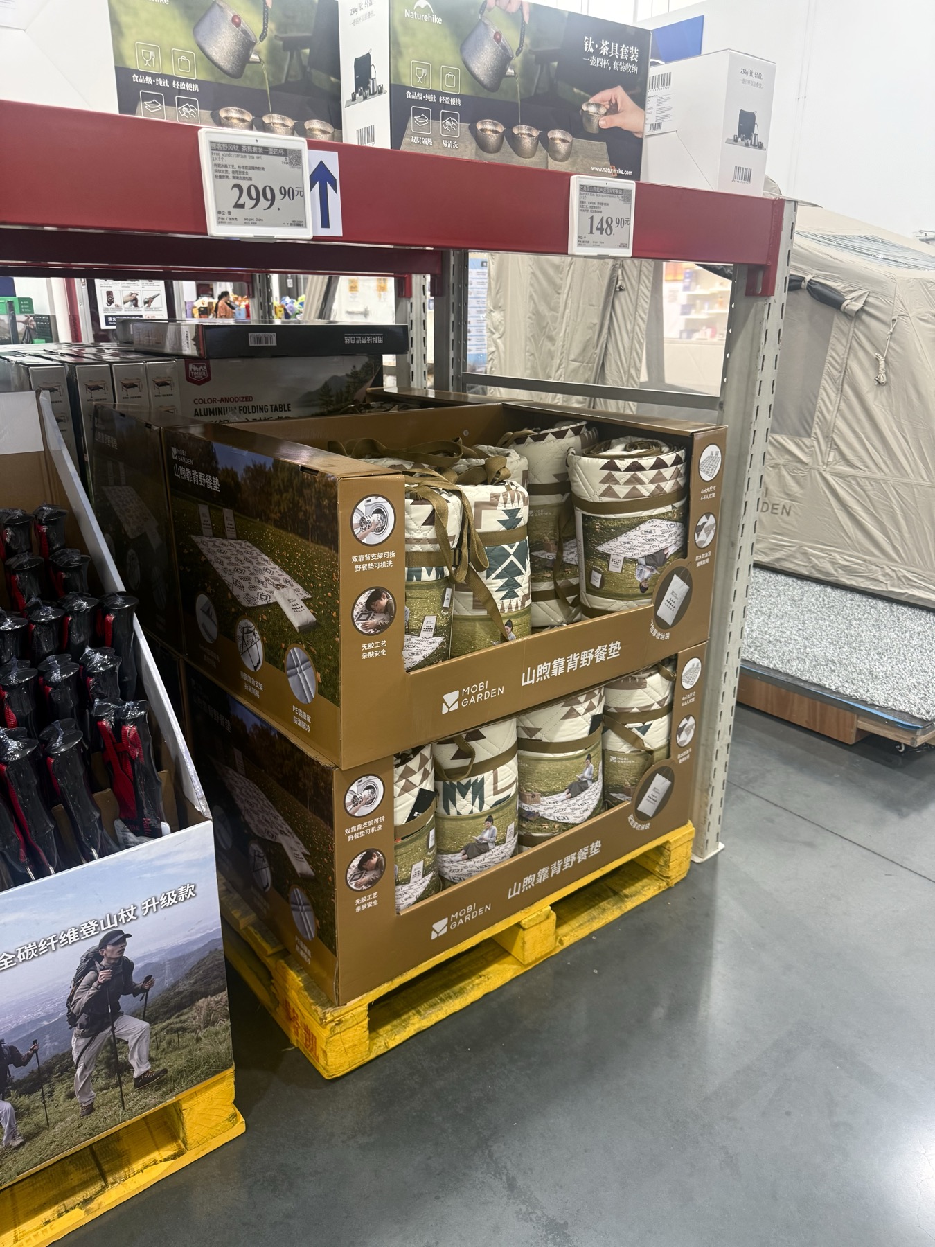 P002 corrugated PDQ displays holding rolled picnic mats in a retail store