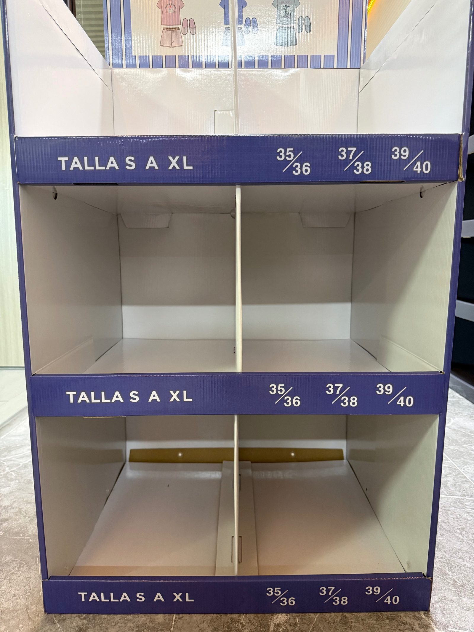 Front view of 3-tier pyjama floor display with divided compartments